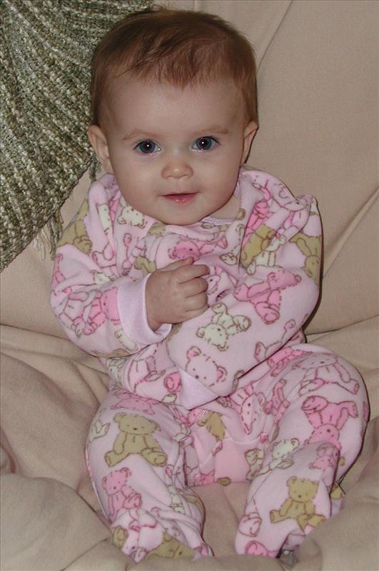Cute and cuddly in her pink, fuzzy, teddy bear pajamas.