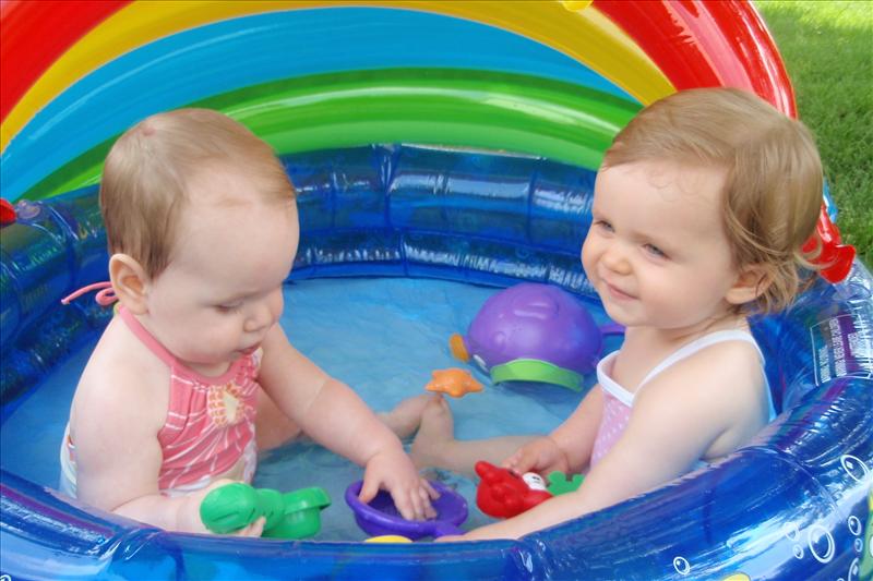 Avery and Molly playing in the pool